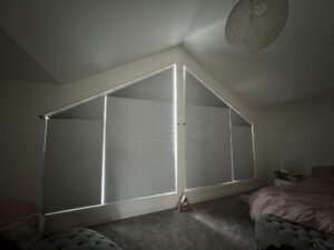 Grey honeycomb blinds installed in a Calgary bedroom for blackout privacy.